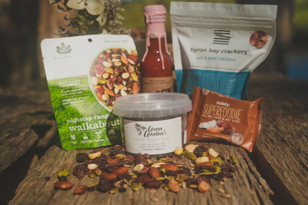 Byron Bay Cookies: White Chocolate & Macadamia Cookies, 75g Barefoot Farm: Dark Chocolate Pecans 130g Crack Fox: Fermented Habanero Hot Sauce 150ml Byron Bay Crackers: Salt & Seed 125g Zentvelds: Chocolate Espresso Beans 50g Duck Creek: Trio Chocolate Macadamias, 36g Grumpy Grandma's: Semi-dried Olives - Tuscan Treats 100g Brookfarm: Nightcap Ranges Trail Mix 75g Holy Nuts: Mini Pure Hazelnut Butter, 35g
